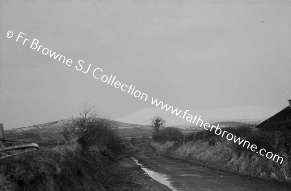 MAN WALKING ALONG ROAD